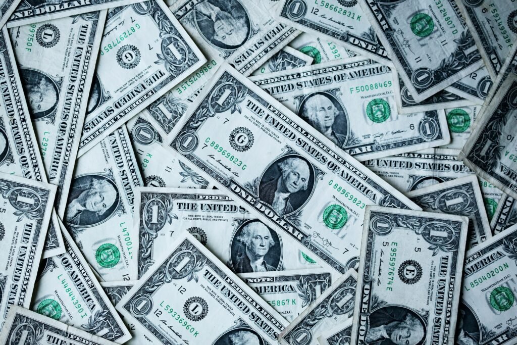 Scattered US dollar bills representing fast MCA business loan funding for small businesses